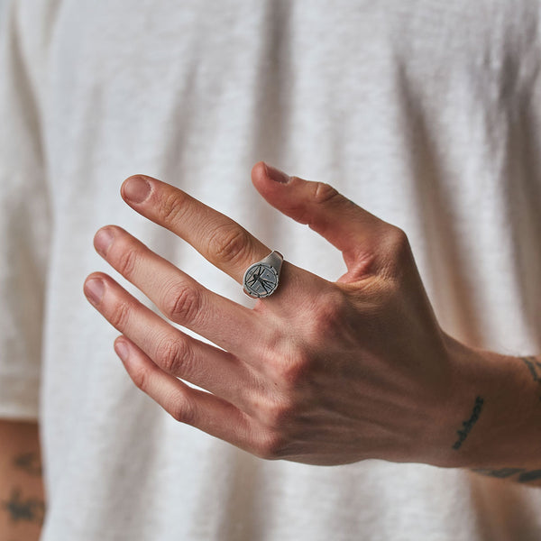 Model hand wearing the Serge DeNimes Vitruvian Man ring on his index finger